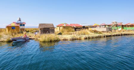 Thatched houses on the floating islands of Lake Titicaca.の写真素材
