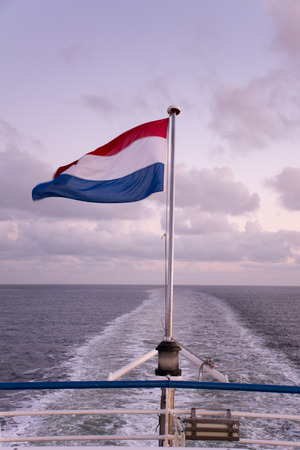 Dutch flag on the back of a shipの写真素材
