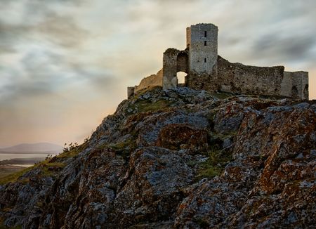 The ruins of an old european fortress against a romantic skyの写真素材