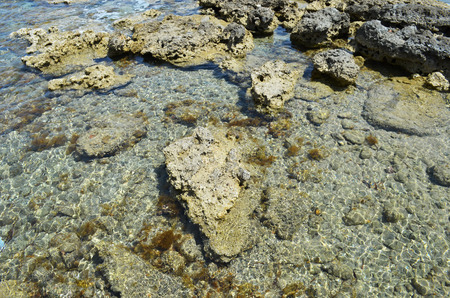 The shore of the Mediterranean in Greece on the island of Rhodes. Filled with volcano stones.の写真素材
