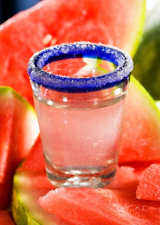 Watermelon infused tequila shot displayed on fresh sliced watermelon.の写真素材