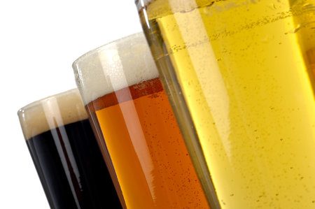 Beer decisions.  Colorful assortment of three beers shot on a white background.