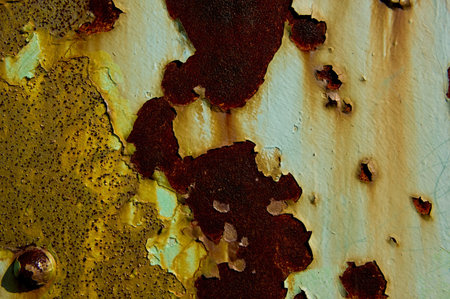Rusted brown metal under peeling green paint on an old bridge.  Background image.