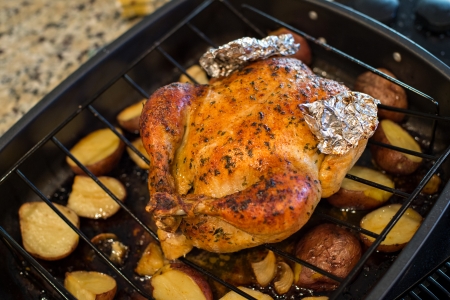 Oven roasted chicken with potatoes just out of the oven.の写真素材