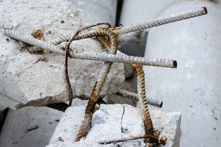 A steel rusty rods in damaged concrete pillars.の写真素材