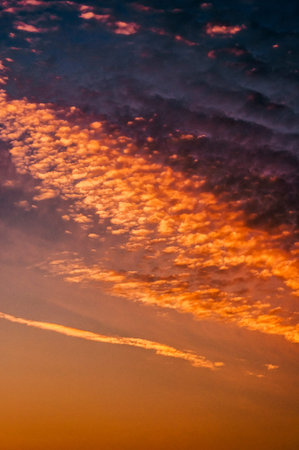 Fabulous cloudscape at sunset with majestic dramatic red and orange clouds