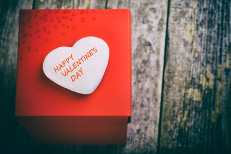 White Heart With Happy Valentine's Day Message On Big Red Gift Box. Toned Image In Vintage Style.