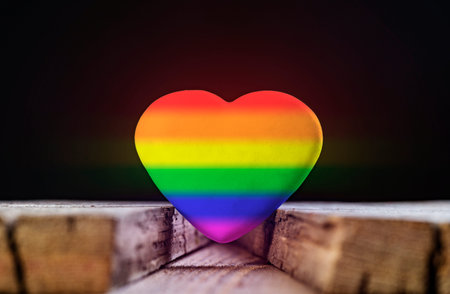 Heart With Rainbow Colors Symbol Of LGBT Between Old Boards On Black Background.