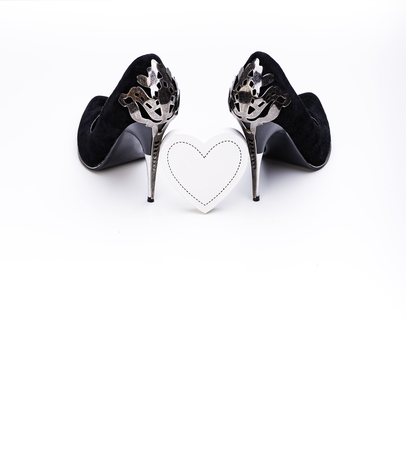 Black High Heels And White Wooden Heart on White Background. Valentine Day, Love Concept.の写真素材