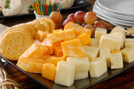 A plate of cheese and crackers on a party buffet tableの写真素材