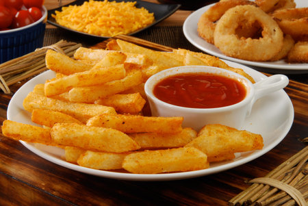 A plate of french fries with catchup