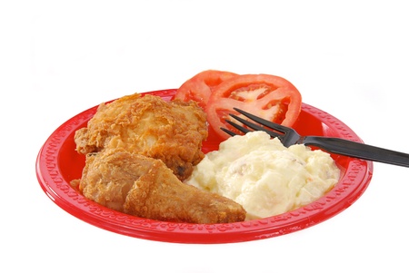 A picnic plate of fried chicken and potto salad on a white backgroundの写真素材