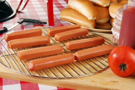 Raw hot dogs on the grill ready to be barbequedの写真素材