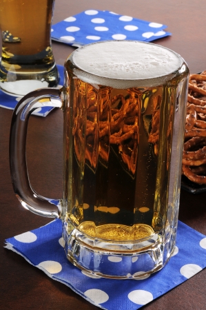 A mug of beer and petzels on a bar counterの写真素材