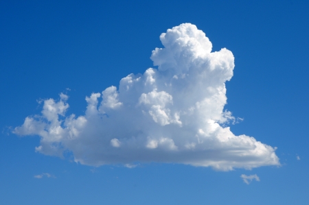 A dense single cloud on a dark blue skyの写真素材