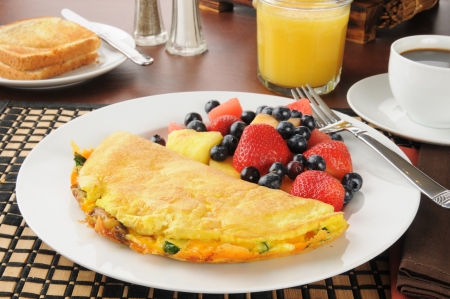 A Western Omelet with fresh fruit and berriesの写真素材