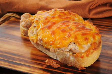 Closeup of a tuna melt topped with cheddar cheeseの写真素材