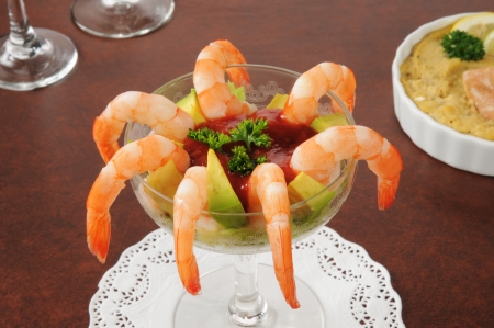A shrimp cocktail with avocado and hummus in the backgoundの写真素材
