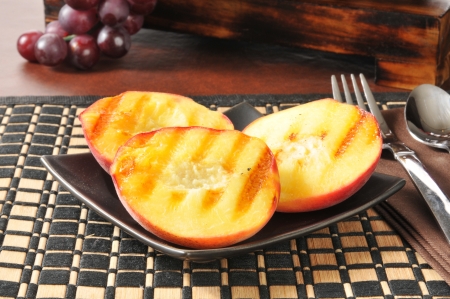 A plate of grilled peaches, a summertime food favoriteの写真素材