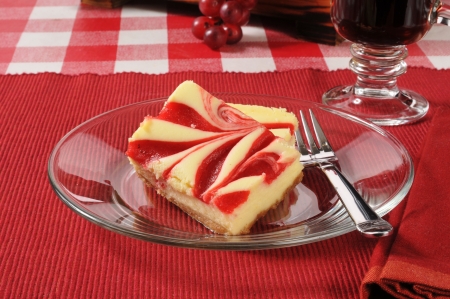 Sliced cheesecake with strawberry swirlsの写真素材