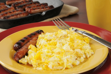 Breakfast of scrambled eggs, link sausage and coffeeの写真素材