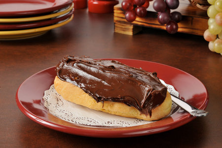 A cream filled eclair with chocolate frosting