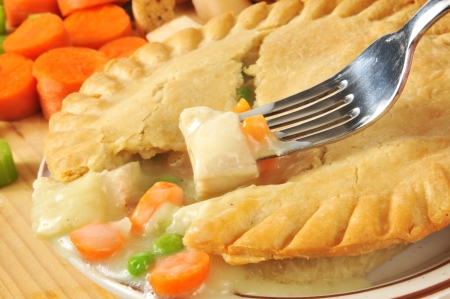 Closeup of a forkful of chicken pot pie with ingredients Closeup of a forkful of chicken pot pie with ingredients