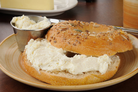 A bagel with cream cheese and coffeeの写真素材