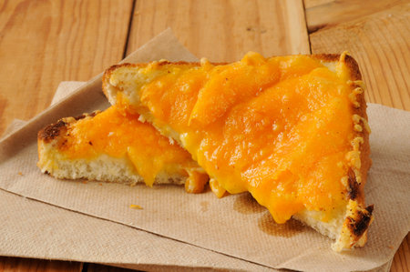 Melted cheddar cheese on sliced Texas toast