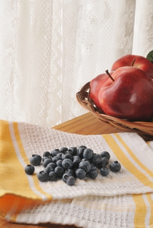 Fresh washed organic blueberries drying on a towel near the kitchen windowの写真素材