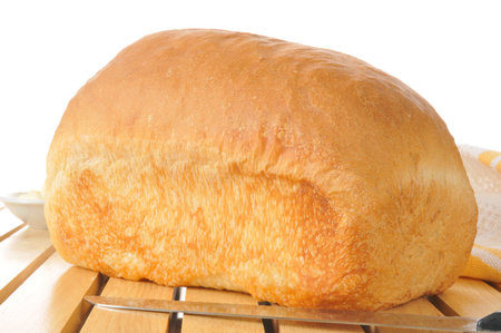 A loaf of fresh baked bread on a cooling rack
