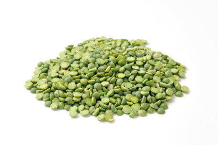 A mound of organic, dried split green peas on a white backgroundの写真素材