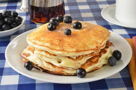 Buttermilk pancakes with blueberries on a picnic tableの写真素材