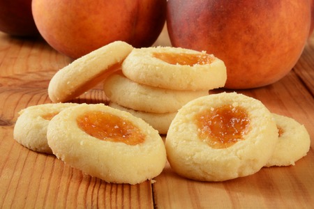 A stack of shortbread cookies filled with peach jamの写真素材