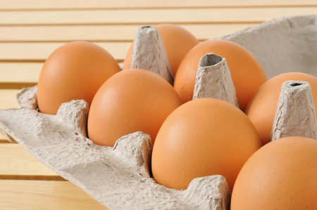 Natural organic brown eggs in the carton, shot closeup