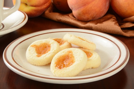 A plate of shortbread cookies with peach jam fillingの写真素材