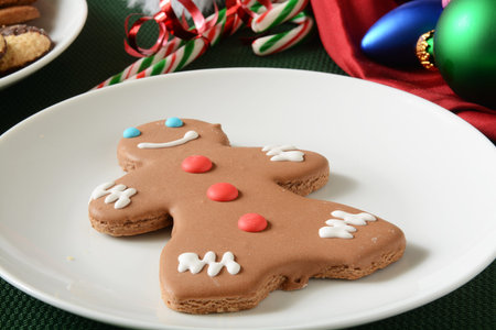 A gingerbread man cookie with candy canes on a Christmas table