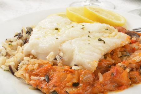 Close up of Cod Provencal on wild rice with lemon