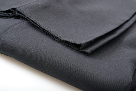 A folded pair of unhemmed mens dress slacks closeupの写真素材