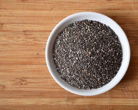 Overhead view of a bowl of black chia seeds with space for copy.の写真素材