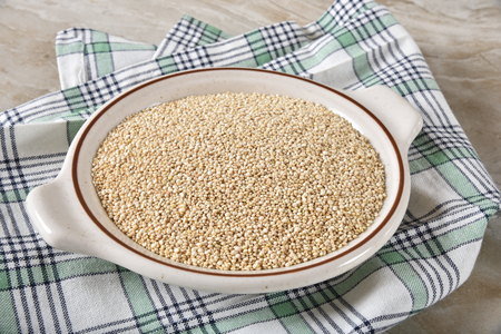 Closeup of a bowl of uncooked quinoaの写真素材