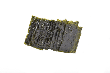 Toasted thin seaweed wafers on a white backgroundの写真素材