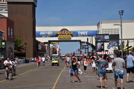 ATLANTIC CITY, NEW JERSEY, USA - JUNE 26, 2019: Tourists enjoying the Atlantic City Boardwalk by the Hard Rock Hotel and Steel Pierのeditorial素材