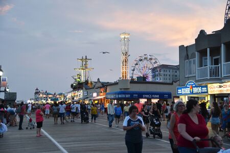 OCEAN CITY, NEW JERSEY/USA - JUNE 27, 2019: Tourists enjoying the famous Ocean City Boardwalk at sunsetのeditorial素材