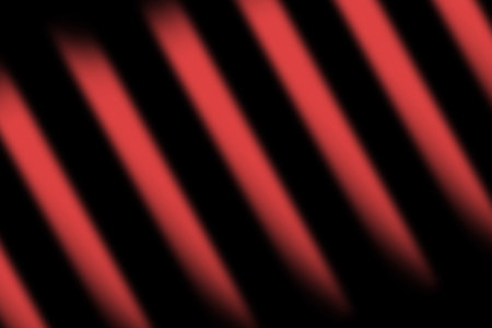 abstract red background with diagonal stripes and spots of light and shadowの写真素材