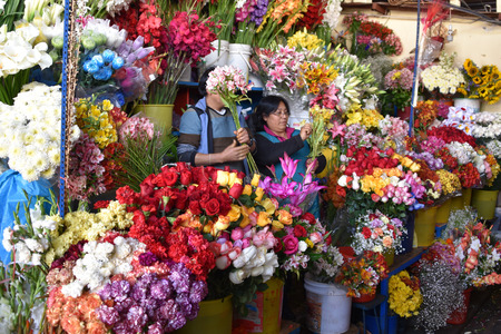 CUZCO, PERU - March 29, 2018: Colorful flowers on sale on a stall in Mercado San Pedro marketのeditorial素材