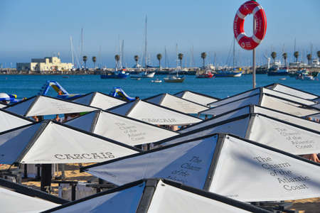 Cascais, Portugal - July 24, 2019: Parasols and sun loungers on the beach in the resort town of Cascais, Portugalのeditorial素材