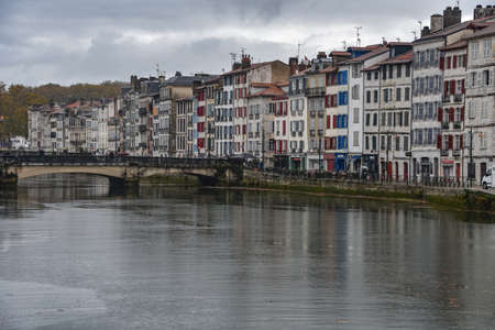 BAYONNE, FRANCE - 30 Oct, 2021: Old houses by the river La Nive in the center of Bayonne, Aquitaine, Franceのeditorial素材