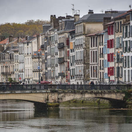 BAYONNE, FRANCE - 30 Oct, 2021: Old houses by the river La Nive in the center of Bayonne, Aquitaine, Franceのeditorial素材