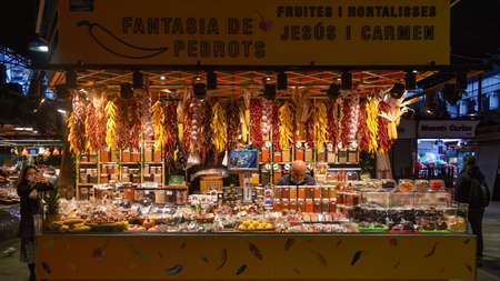 Barcelona, Spain - 23 Nov, 2021: Spices and chilli peppers on sale on a markets stall in the Mercat de la Boqueria, Barcelona, Spainのeditorial素材
